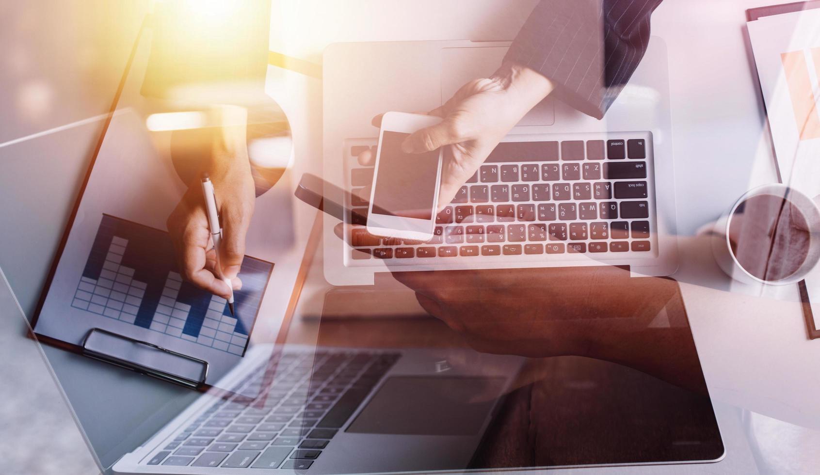 businesswoman hand working with laptop computer, tablet and smart phone in modern office with virtual icon diagram at modernoffice in morning light photo