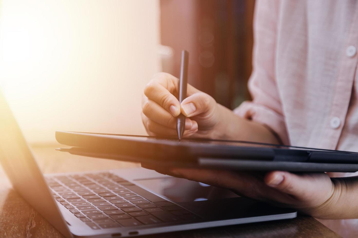 businesswoman hand working with laptop computer, tablet and smart phone in modern office with virtual icon diagram at modernoffice in morning light photo