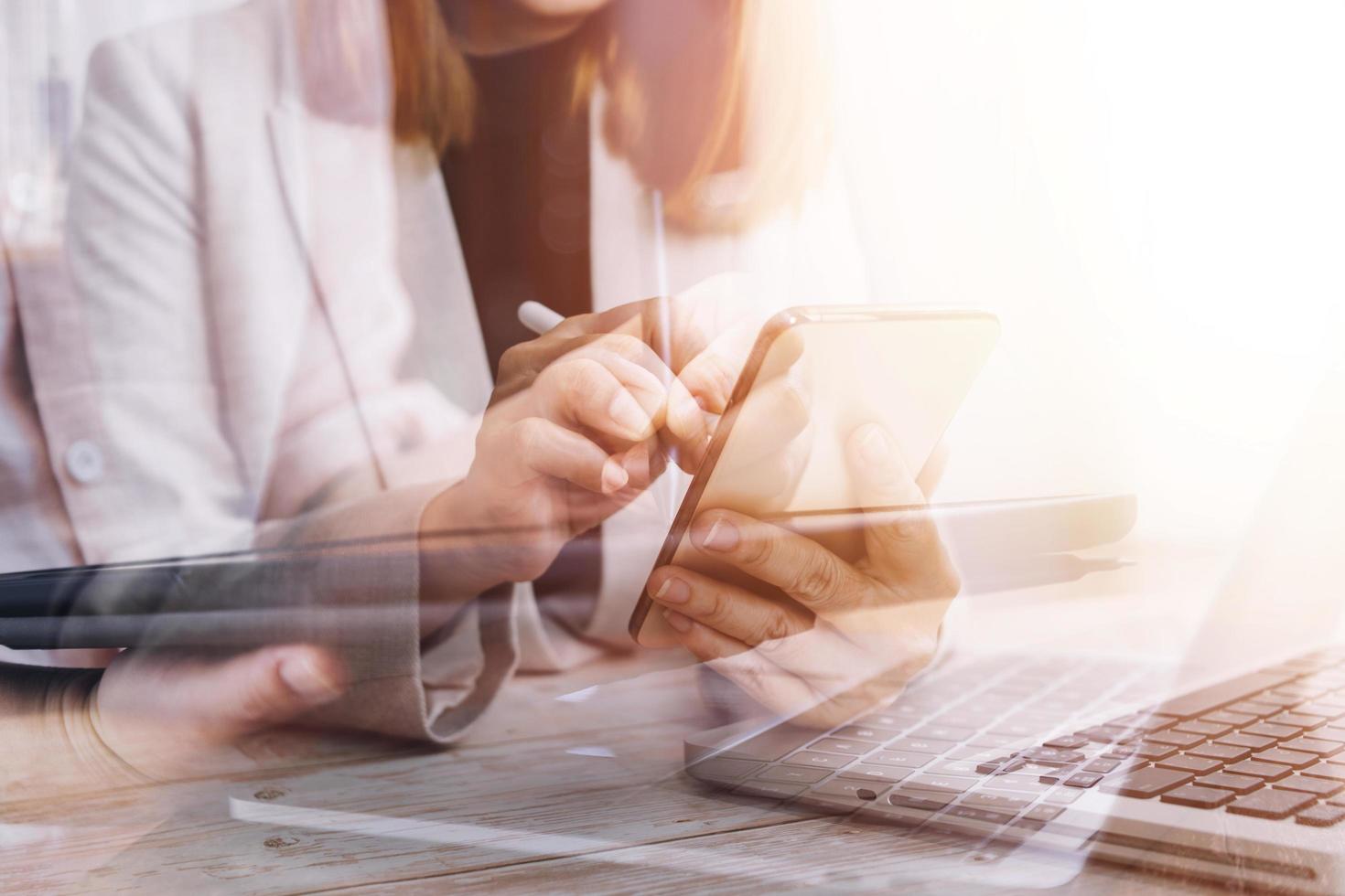 businesswoman hand working with laptop computer, tablet and smart phone in modern office with virtual icon diagram at modernoffice in morning light photo