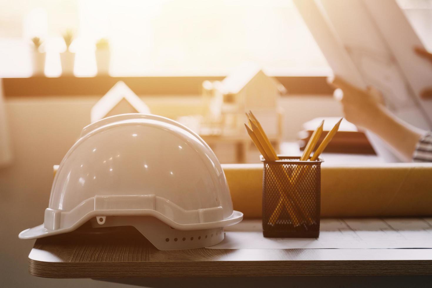 Construction engineer working at blueprint to build large commercial buildings in office. Engineering tools and construction concept. photo