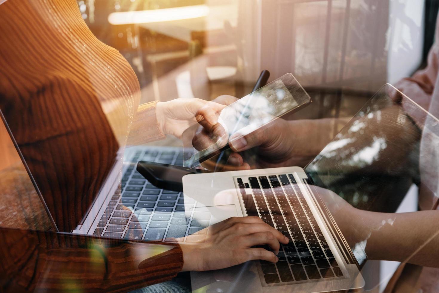 businesswoman hand working with laptop computer, tablet and smart phone in modern office with virtual icon diagram at modernoffice in morning light photo