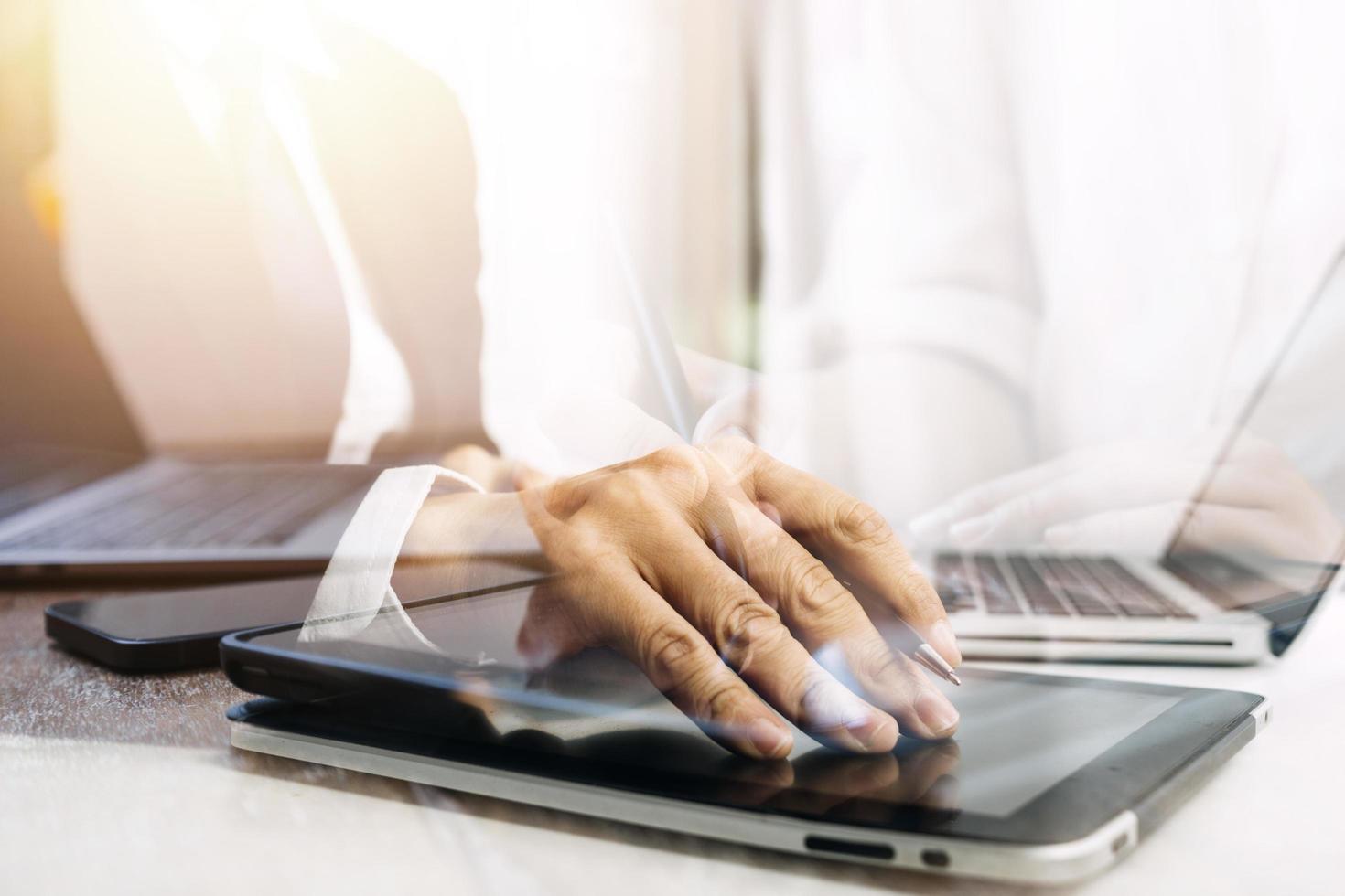 businesswoman hand working with laptop computer, tablet and smart phone in modern office with virtual icon diagram at modernoffice in morning light photo