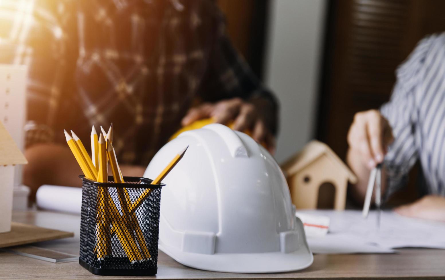 Construction engineer working at blueprint to build large commercial buildings in office. Engineering tools and construction concept. photo