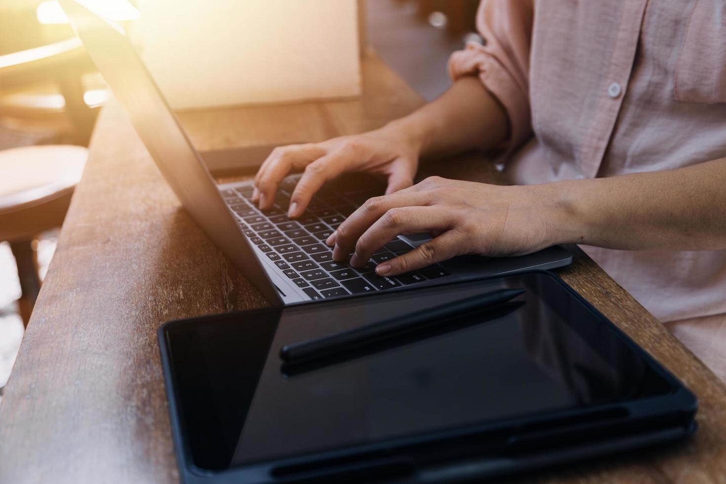 businesswoman hand working with laptop computer, tablet and smart phone in modern office with virtual icon diagram at modernoffice in morning light photo