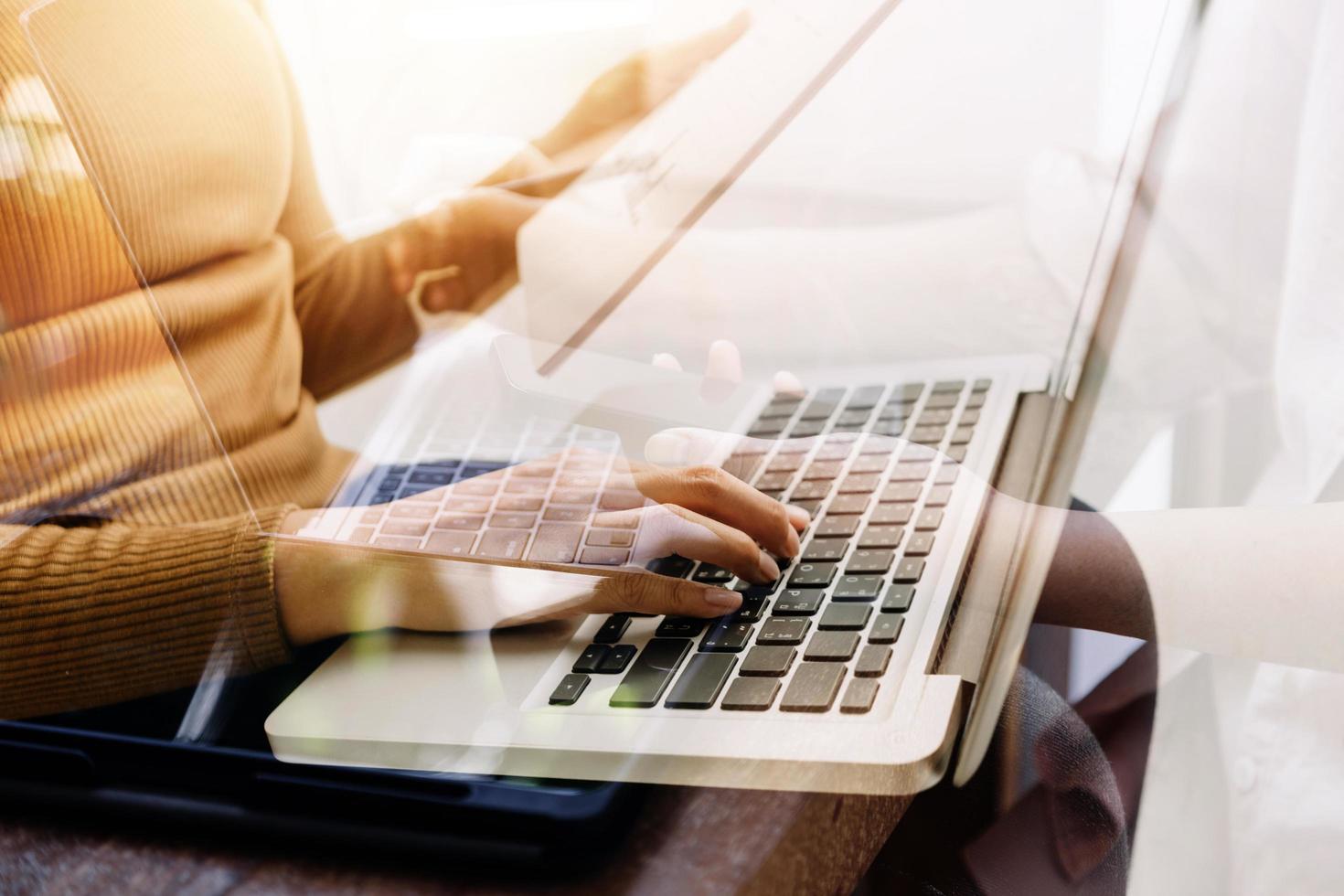 businesswoman hand working with laptop computer, tablet and smart phone in modern office with virtual icon diagram at modernoffice in morning light photo