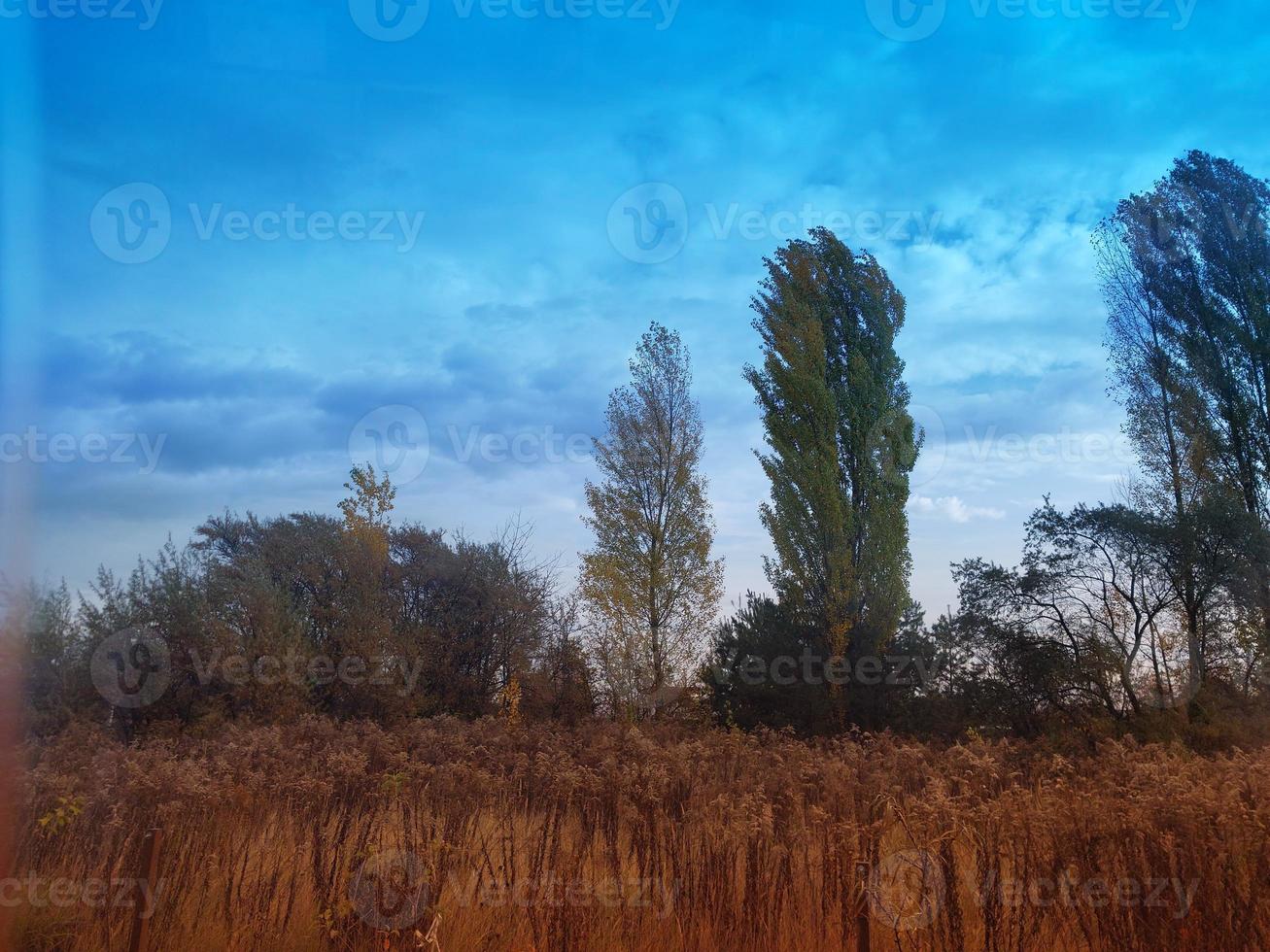 Multi-colored clouds fly over the village photo