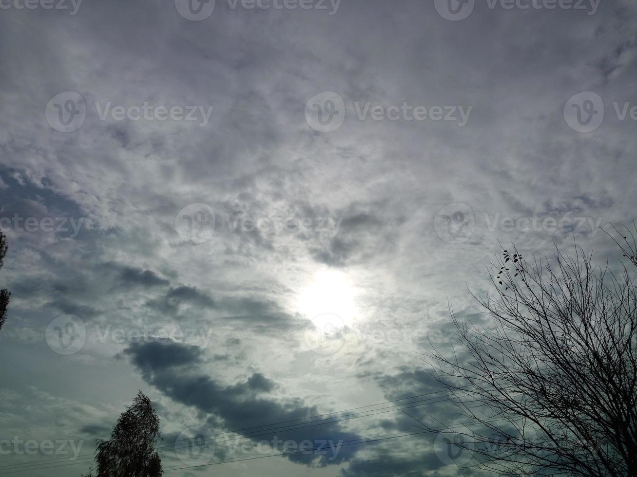 Multi-colored clouds fly over the village photo