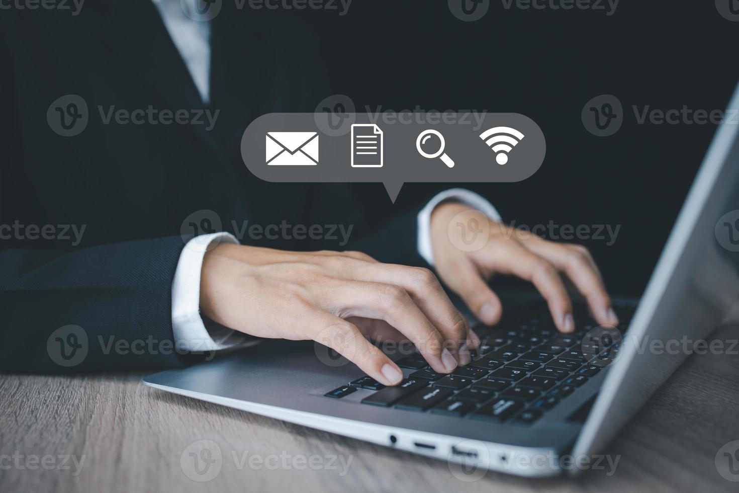Businessman using a laptop and touching on virtual screen contact icons email, address, live chat, internet wifi. Contact us or Customer support hotline people connect. photo