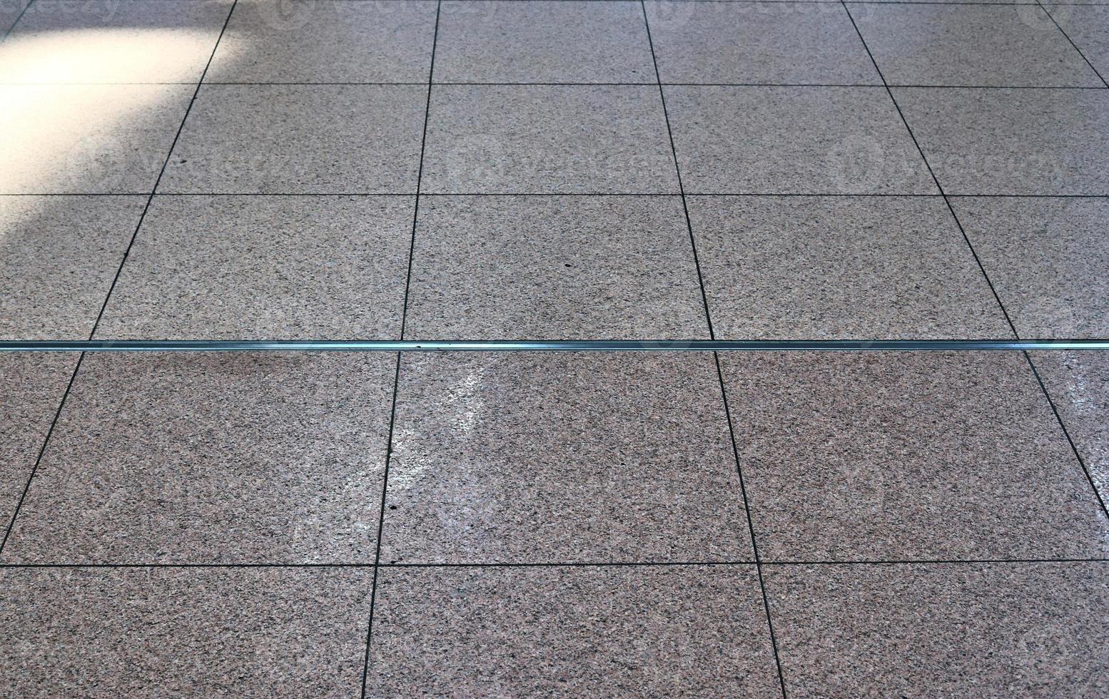 Detailed close up texture on structured floor tiles on the ground photo