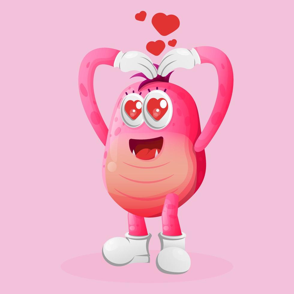 Monstruo rosado lindo con mano de signo de corazón de amor vector