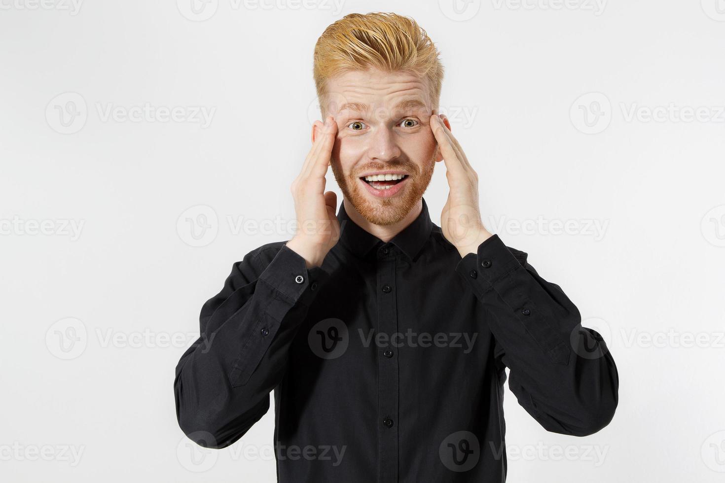 Excited surprised shock young man isolated on gray background. Happy Redhead guy with red beard in black stylish shirt. Success and pass exam concept. Copy space. Close up of Face expression. photo