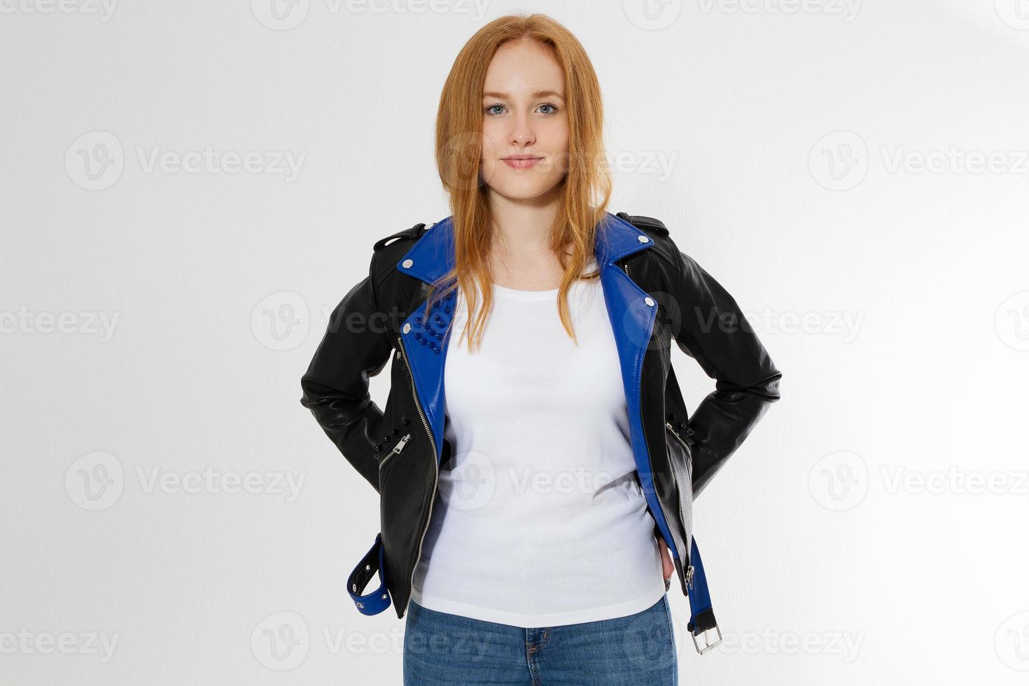 Woman in white t shirt and black leather jacket isolated on white background. Red hair girl in fashion clothes front view. Blank template summer t-shirt. Copy space photo