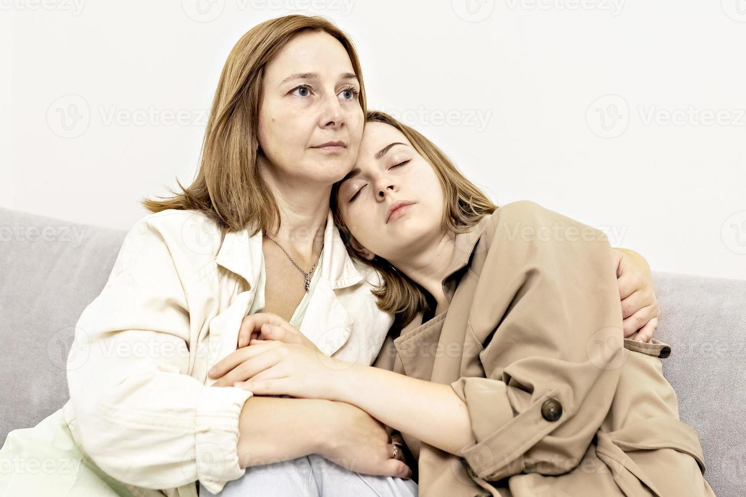 Parents and teens.Mom and teenage daughter are sitting on the couch. Conflict, difficult age. Family. photo