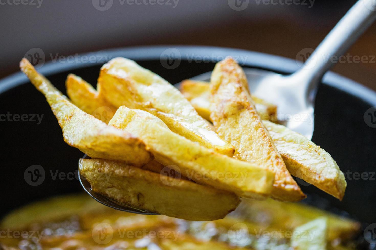 Homemade fries in oil 13848088 Stock Photo at Vecteezy
