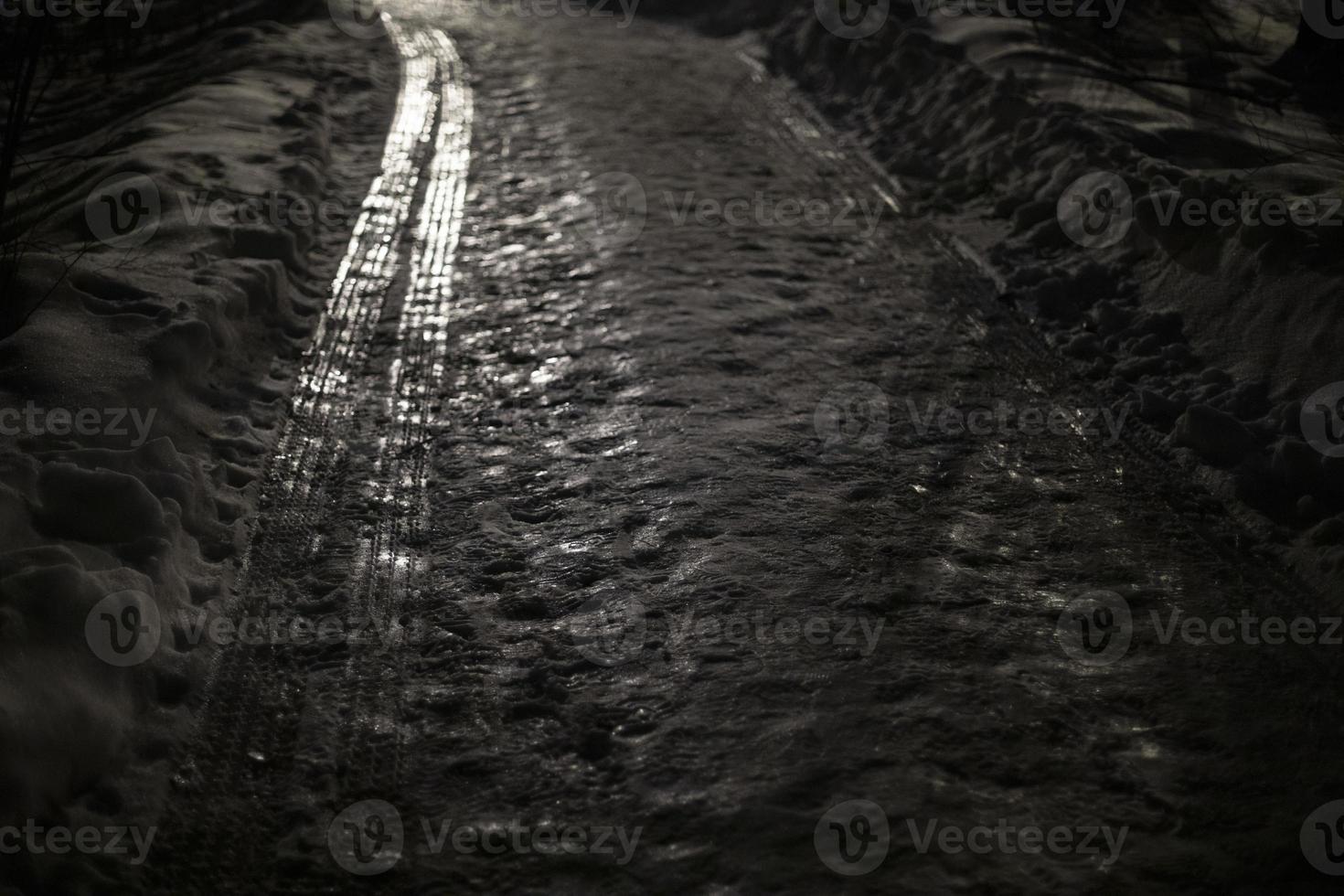 Road in park in winter. Ice on road. photo