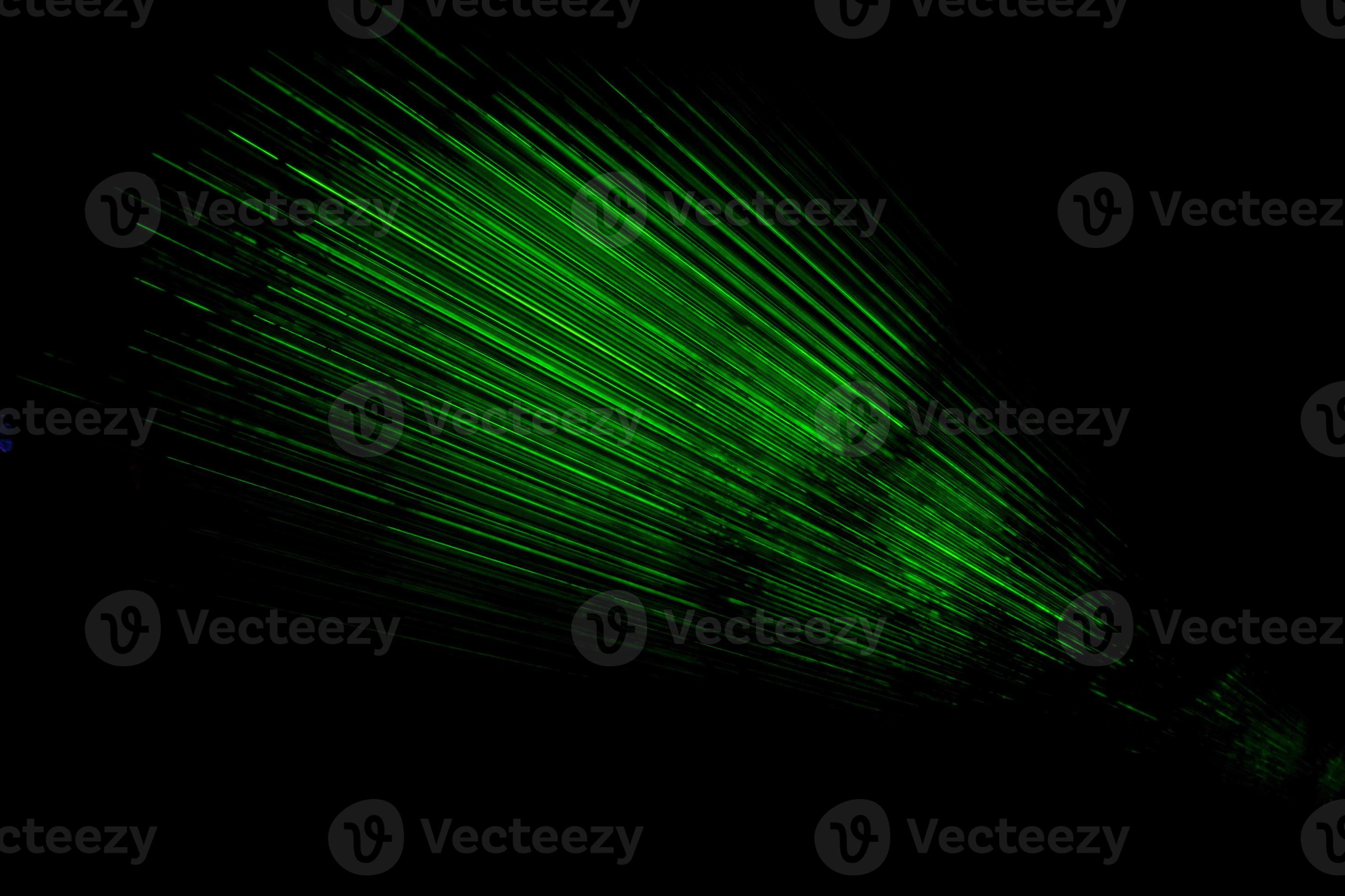 Laser in dark. Green rays on black background. Laser radiation in space