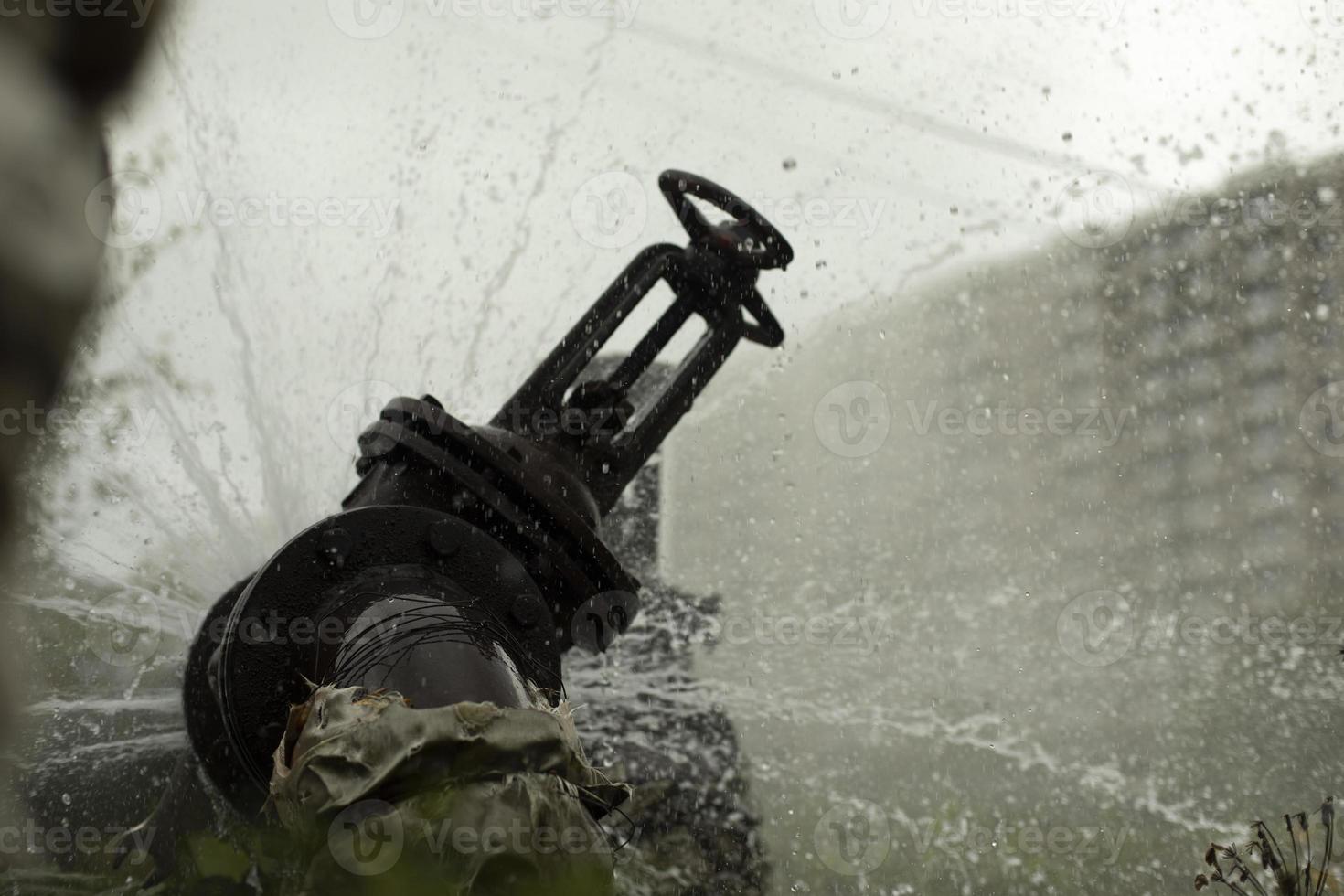 Breakthrough heating pipe. Pipeline accident. Boiling water pours out. photo