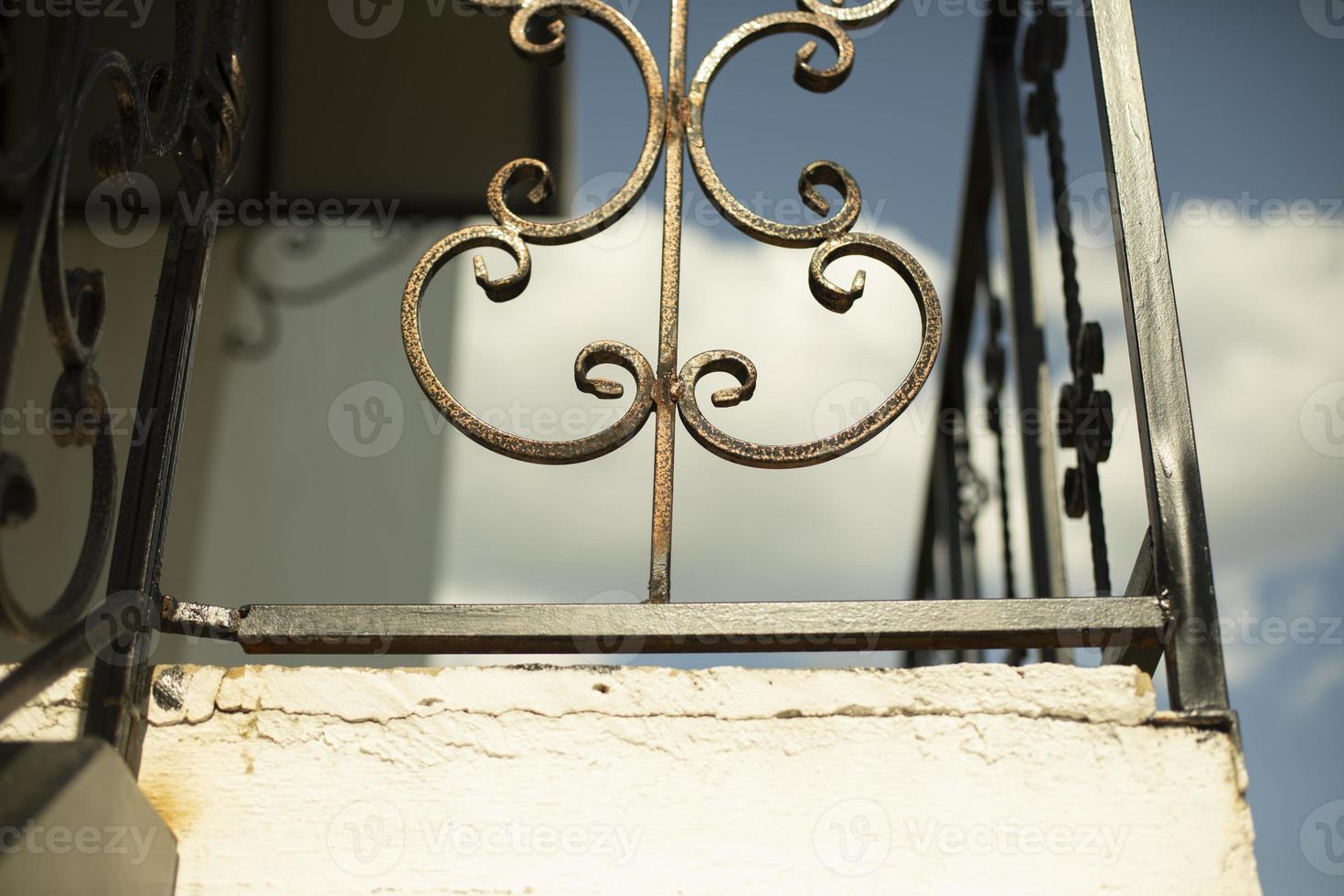 Steel fence on balcony. Forged steel in building. Decoration of facade of house. photo