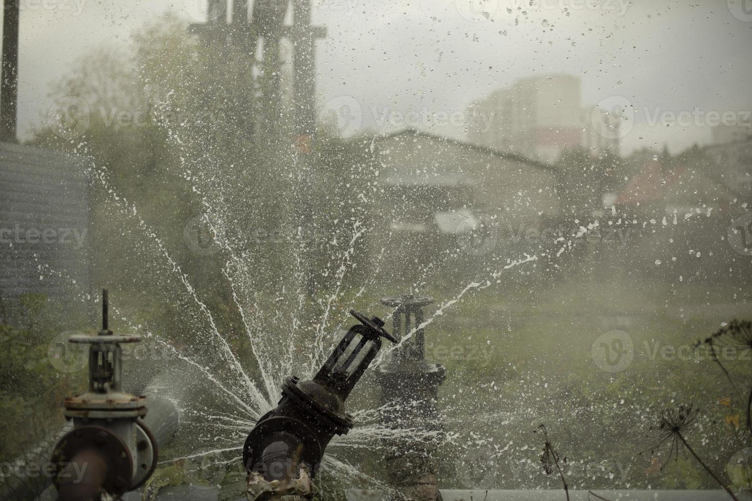 Pipeline accident. Water pours out of pipe. Emergency. photo