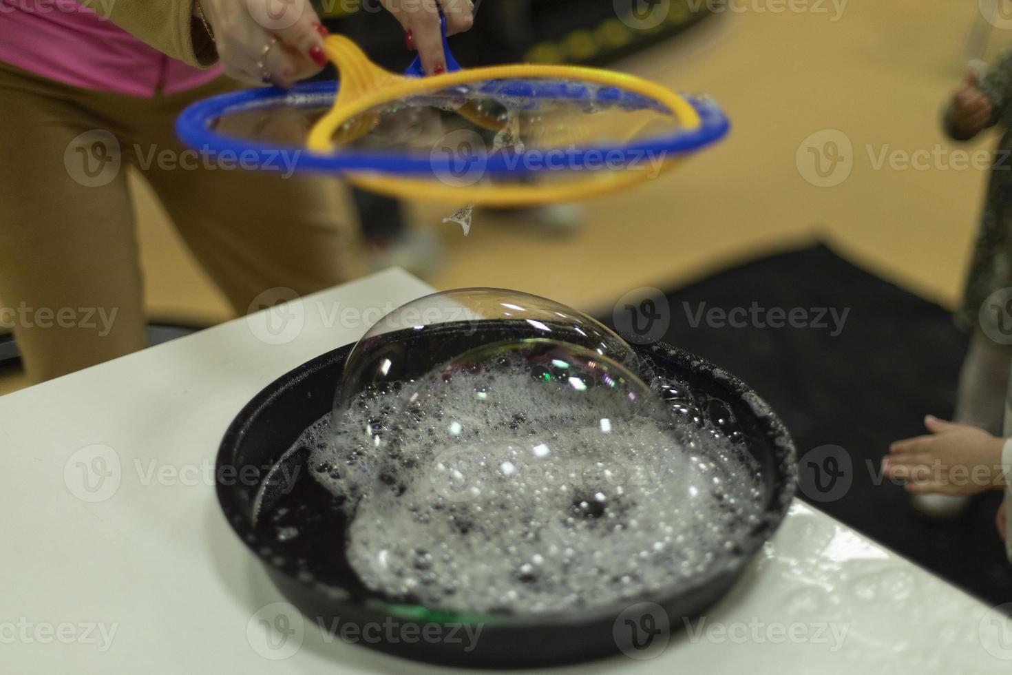 Bubbles. Soap solution for inflatable bubbles. Liquid for entertainment. Details of children's holiday. photo
