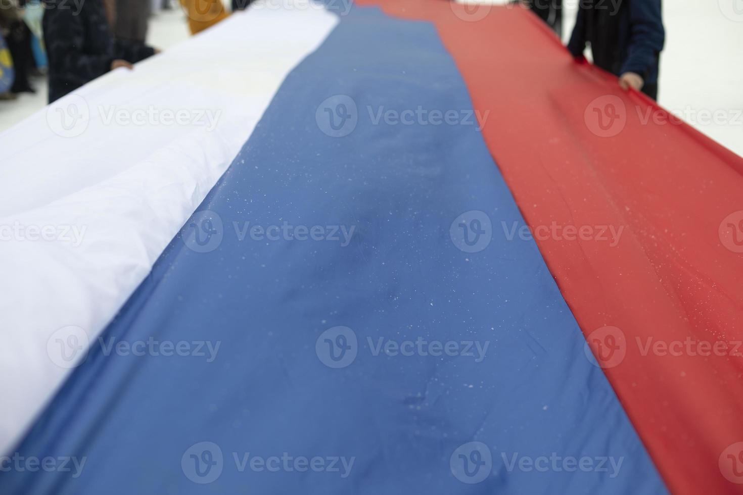 Flag of Russia. People hold fabric. photo