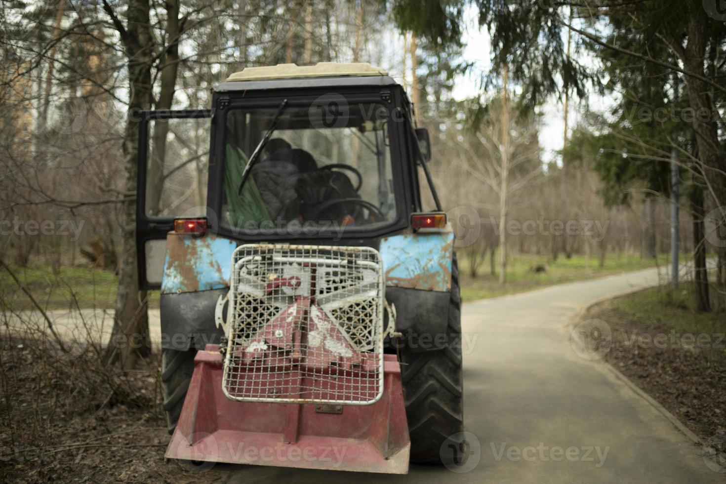 Harvesting equipment in park. Heavy technical with large wheels. photo