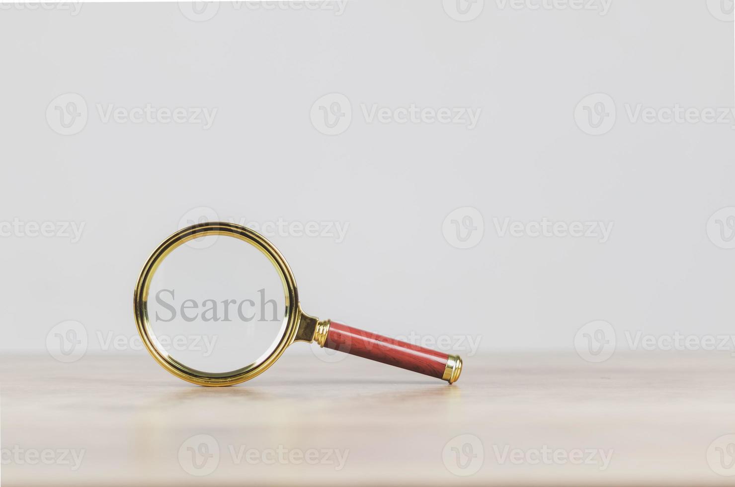 search engine optimization concept  a magnifying glass showing to search for information on social media via the Internet online photo