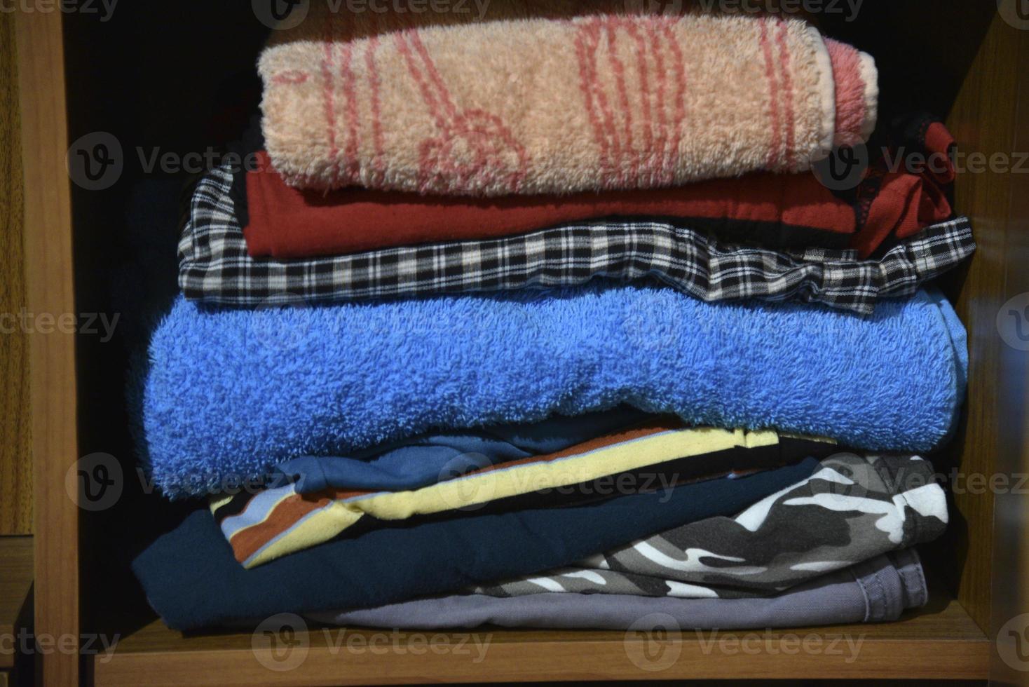 Stored underwear and clothes in the closet. Clothes put on a shelf in the closet. photo