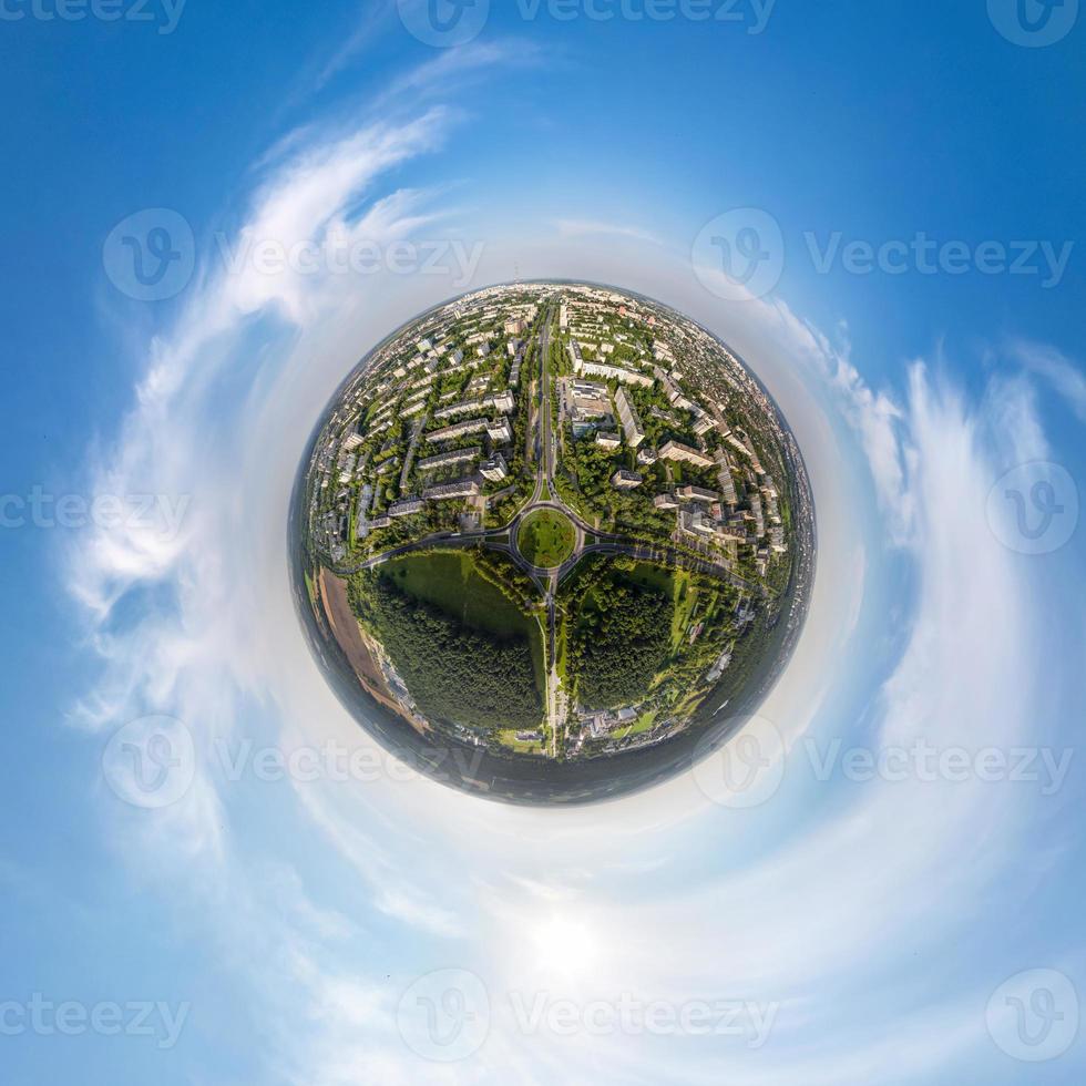 tiny planet in sky with clouds overlooking old town, urban development, historic buildings and crossroads. Transformation of spherical 360 panorama in abstract aerial view. photo