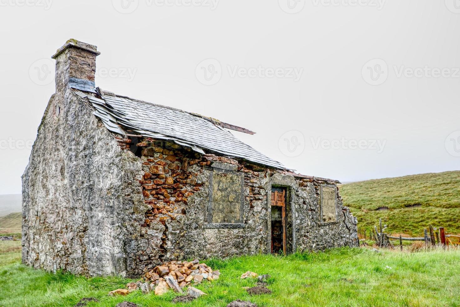 stone building with Yorkshire Dales United Kingdom in the background photo