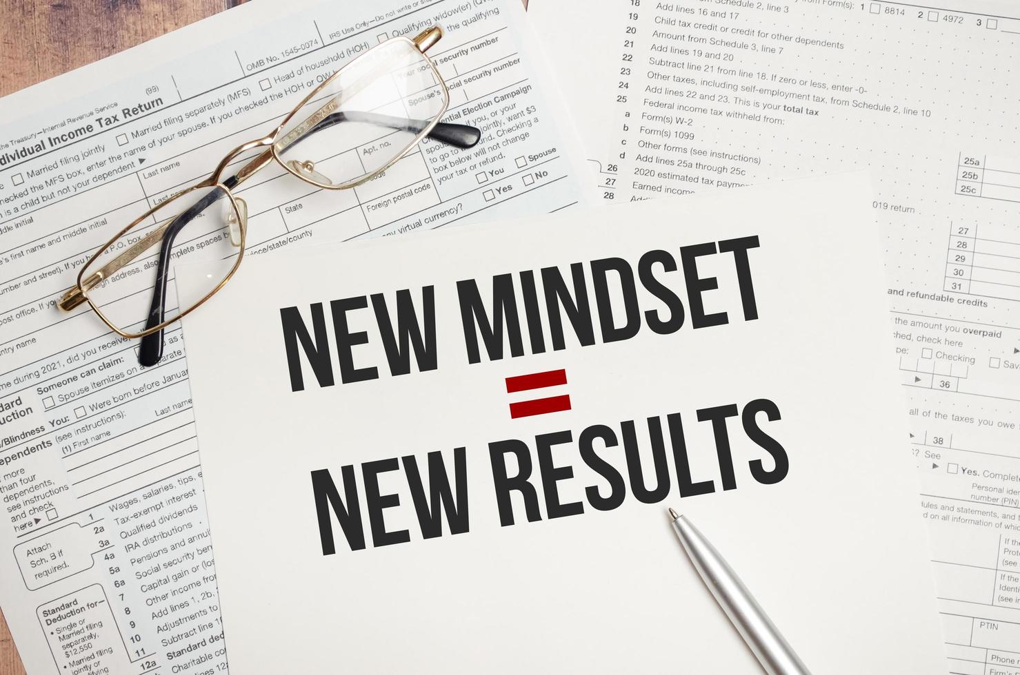 New Mindset - New Results text on paper and tax forms photo