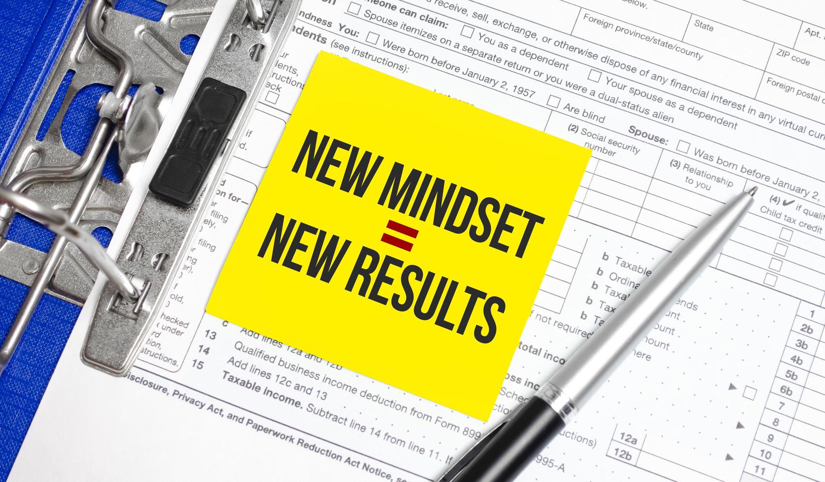 Text New Mindset - New Results on white paper with tax forms photo