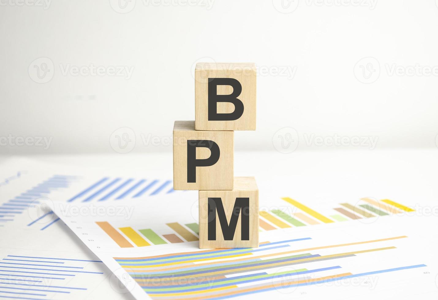 BPM Business Process Management concept, wooden blocks and charts on white background photo