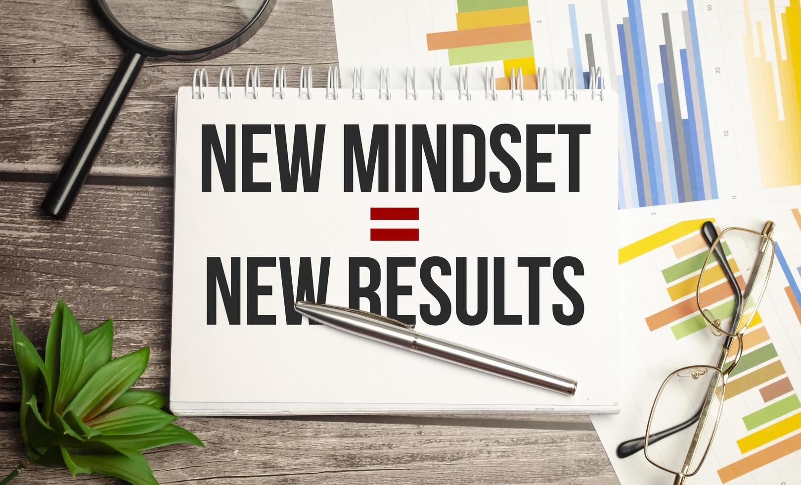 New Mindset - New Results on paper and charts with glasses photo