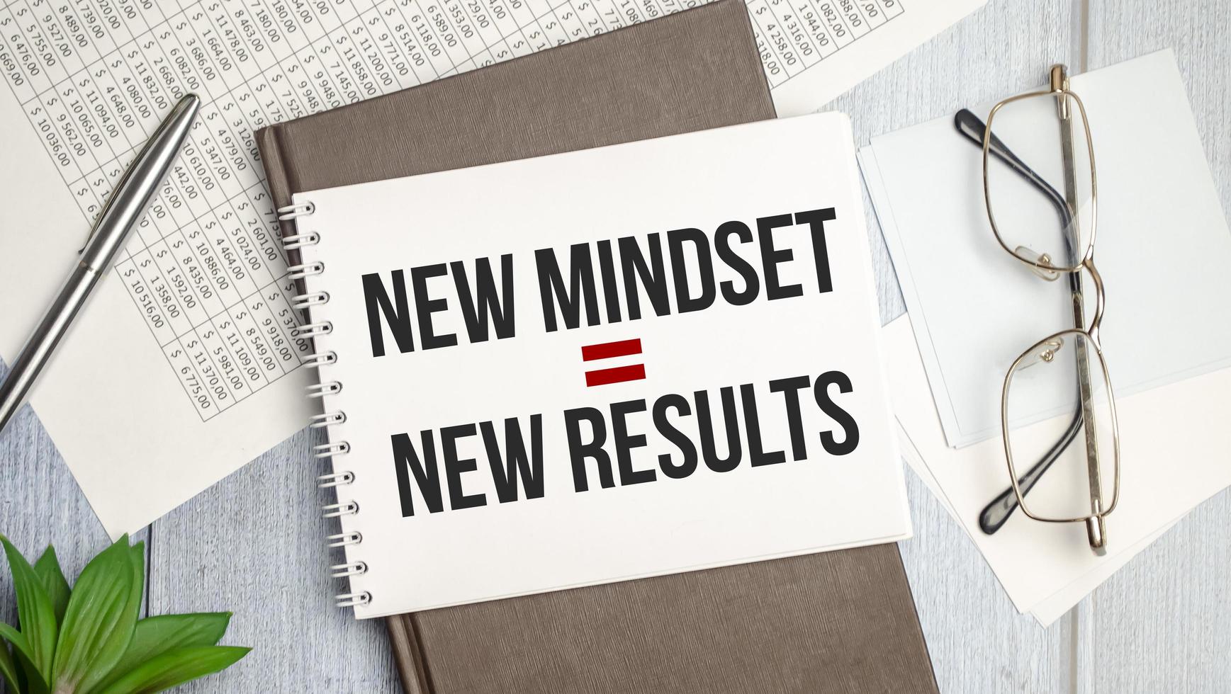 New Mindset - New Results on brown diary and blue background photo