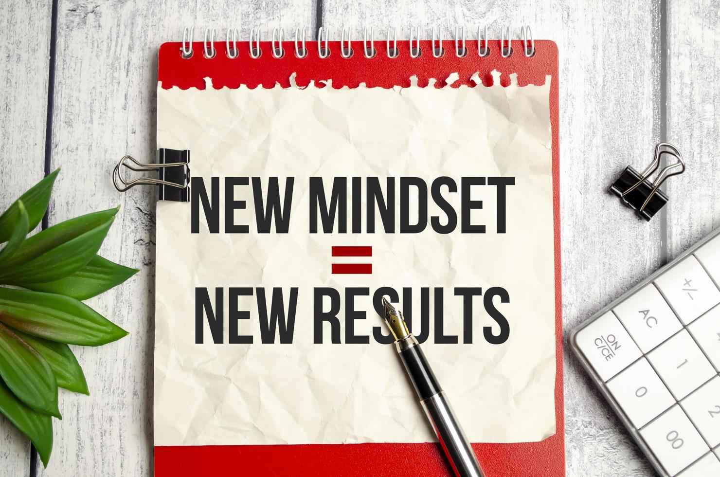 New Mindset - New Results on red notebook and wooden background photo