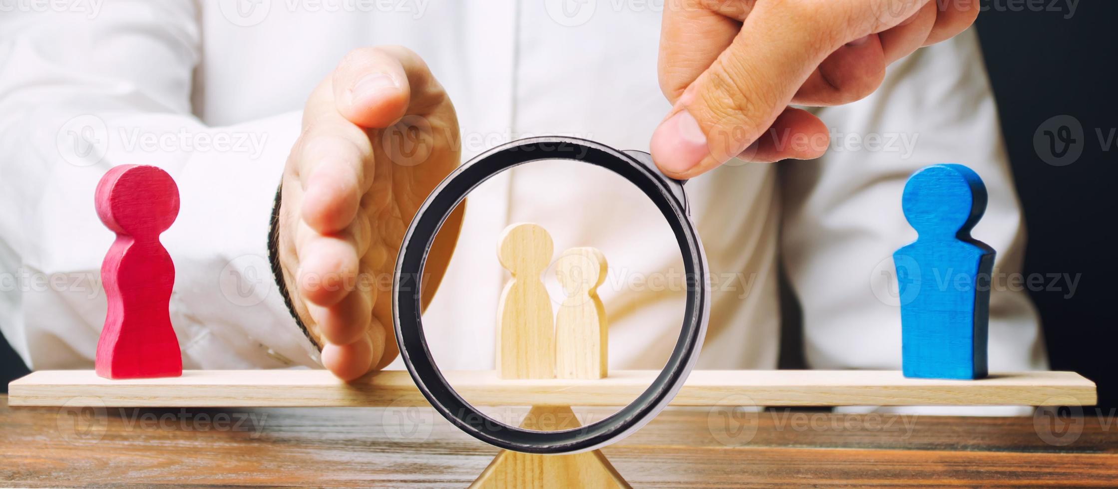 A magnifying glass looks at a man with a palm separates children from mother to father. Depriving a mother of parental rights and transferring children under guardianship. Child custody after divorce. photo