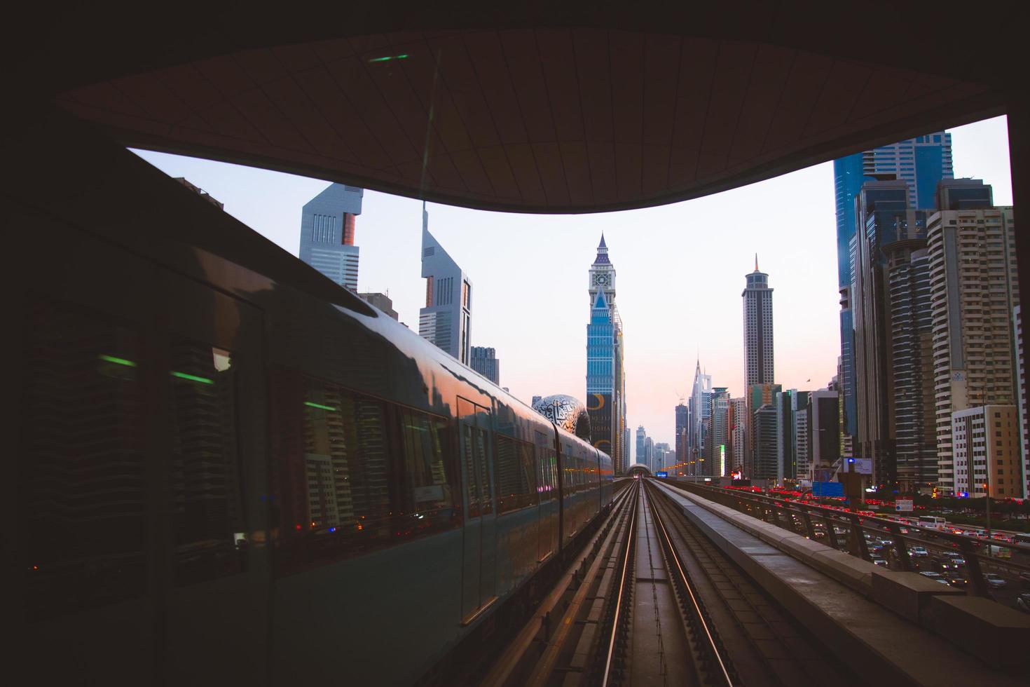 Dubai, UAE, 2022 - metro arrives to metro stop in city of Dubai with scenic modern buildings panorama background photo