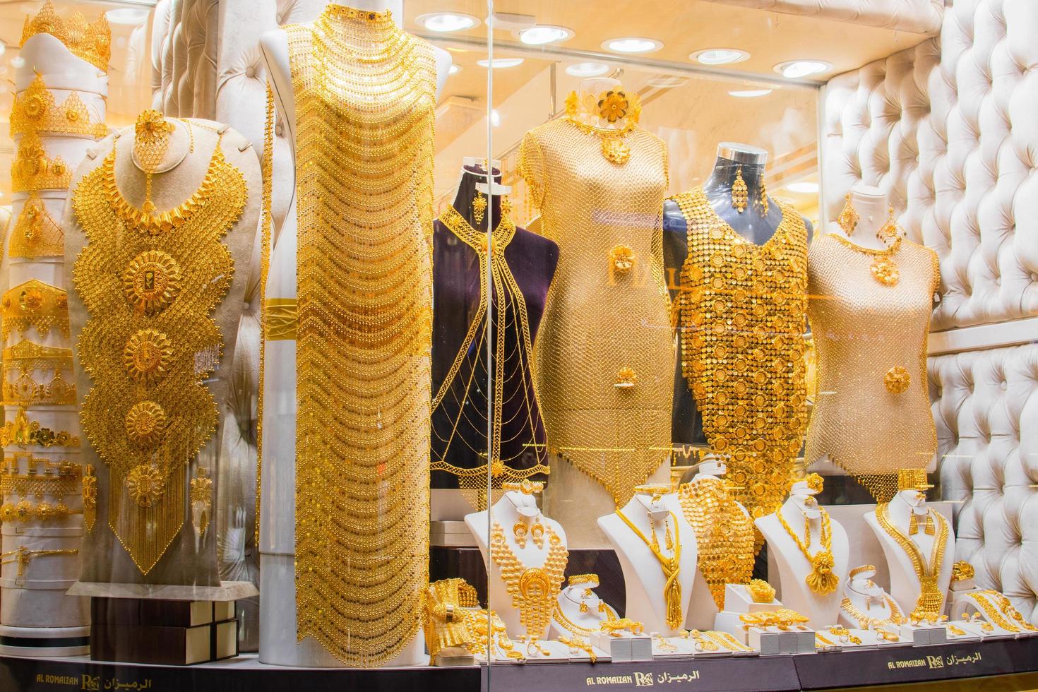 Dubai, UAE, 2022 - most expensive shop items - luxury golden dresses and outfits for woman on shop display in gold souk in old Dubai photo