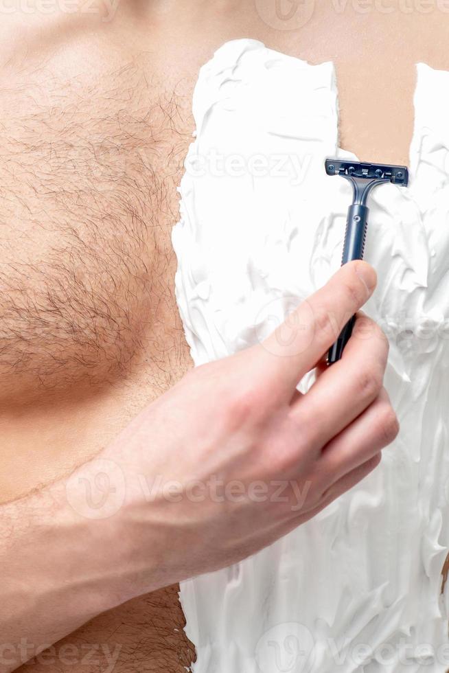 Young man shaving his chest 13849923 Stock Photo at Vecteezy