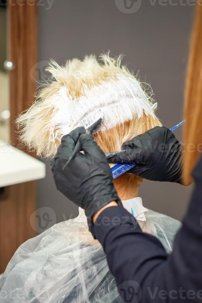 Dyeing hair of young woman. photo