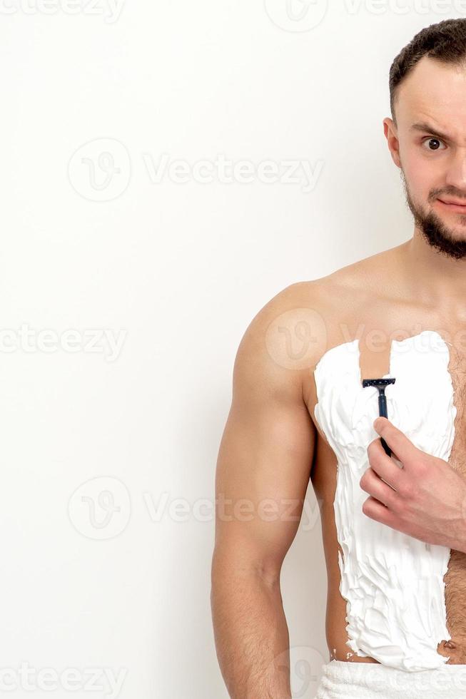 Young man shaving his chest 13850006 Stock Photo at Vecteezy