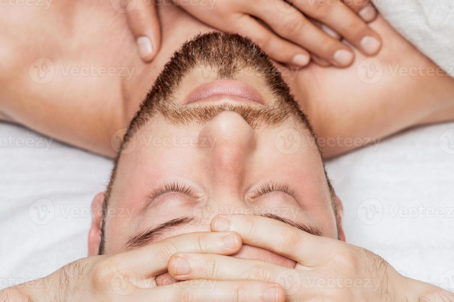 Man receiving relaxing head massage. photo