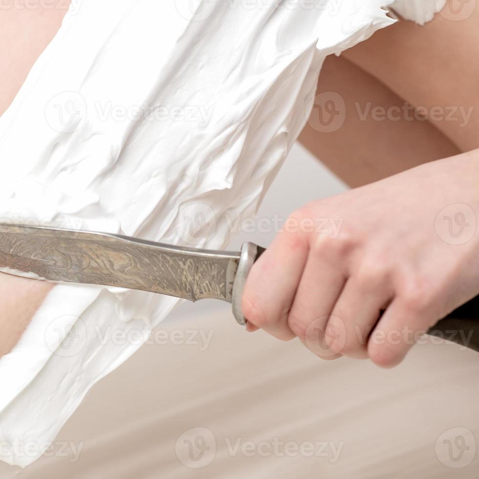 Legs of woman shaving by knife photo