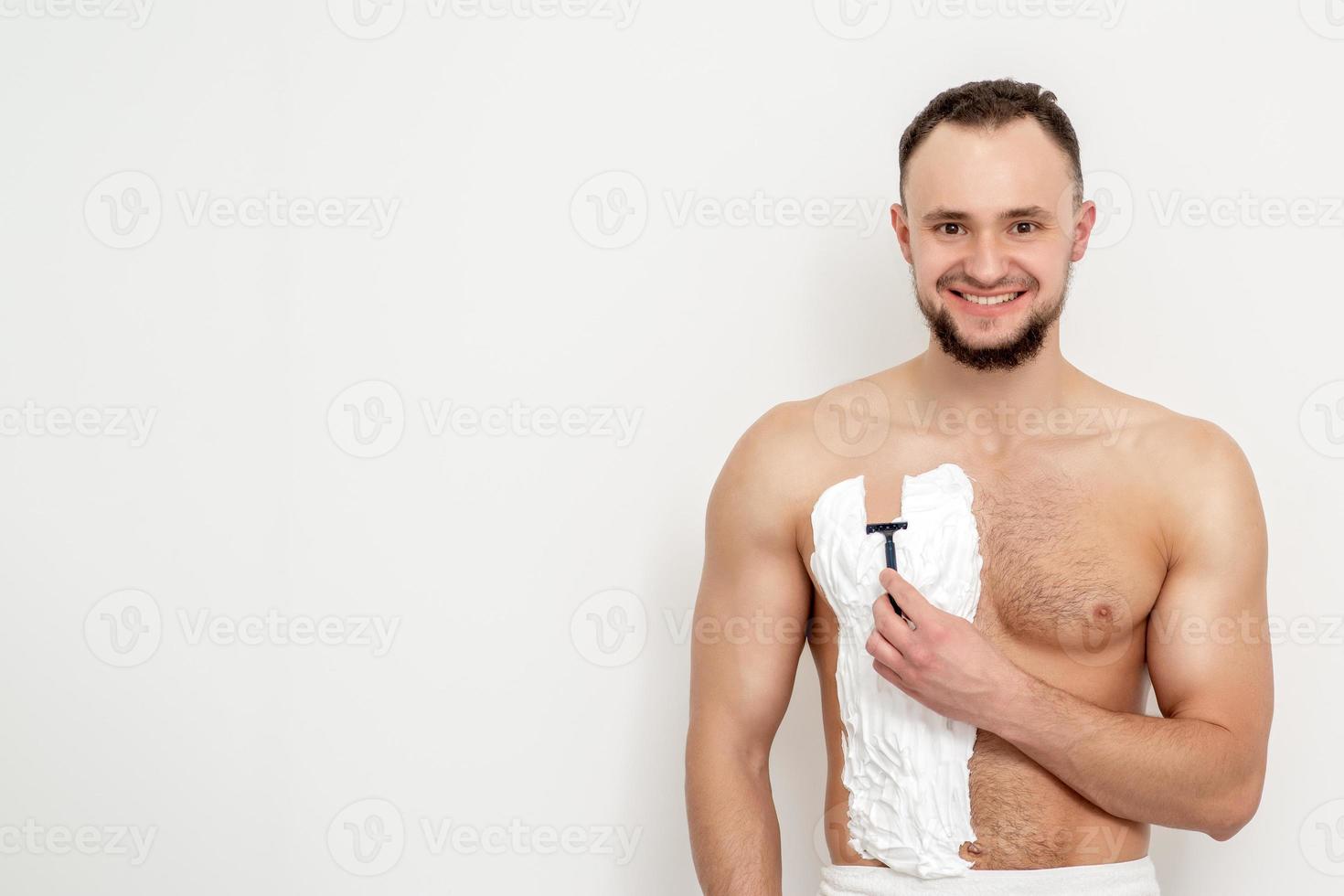 Young man shaving his chest 13850101 Stock Photo at Vecteezy