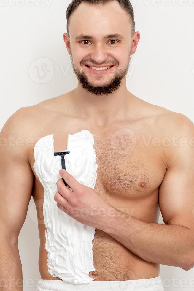 Young man shaving his chest 13850135 Stock Photo at Vecteezy