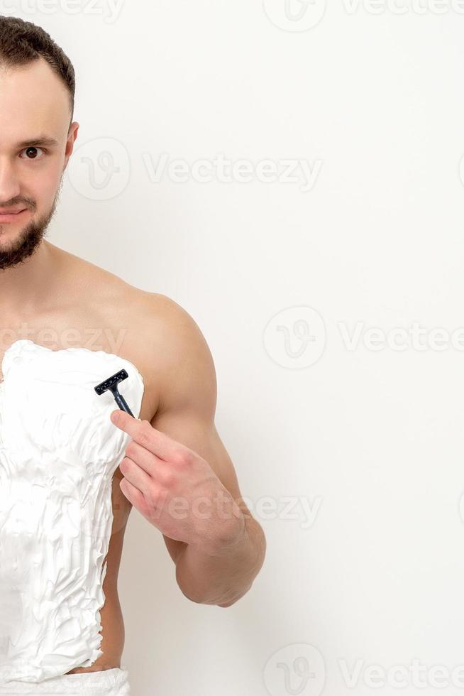 Young man shaving his chest 13850158 Stock Photo at Vecteezy
