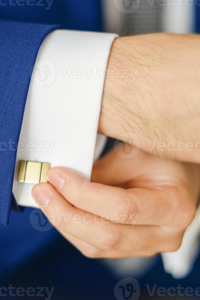 Groom or businessman fasten cufflink photo