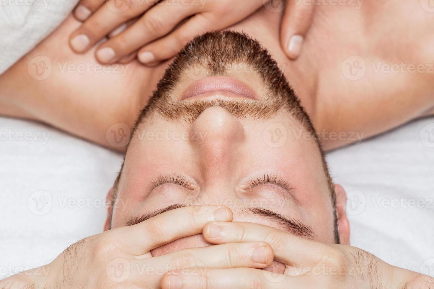 Head massage of young man photo