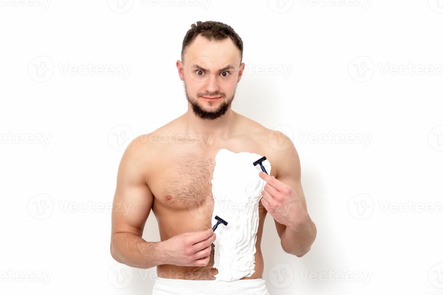 Young man shaving his chest photo